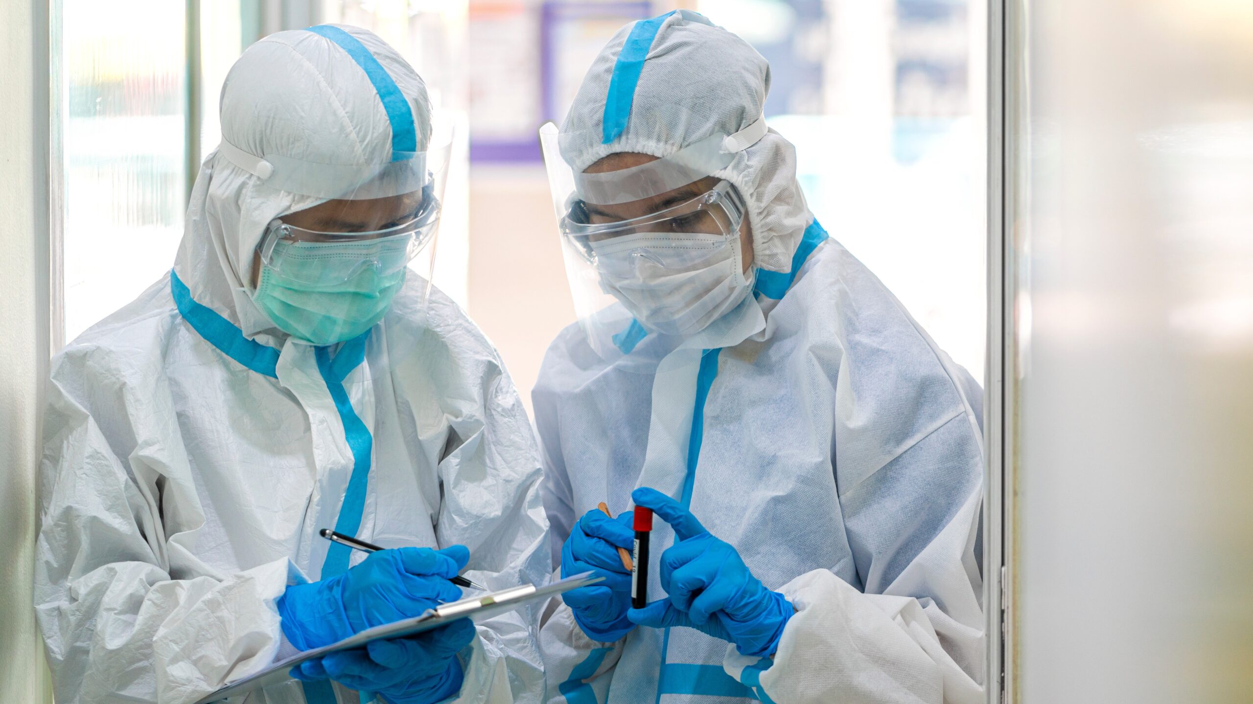 Banner photo of Asian doctor show corona or covid-19 blooding tube wearing ppe suit and face mask in hospital. Corona virus, Covid-19, medical mask, hospital, quarantine or virus outbreak concept